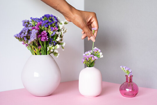 Arranging colorful flowers in elegant ceramic vases