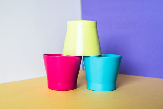 Colorful pots on vibrant geometric background