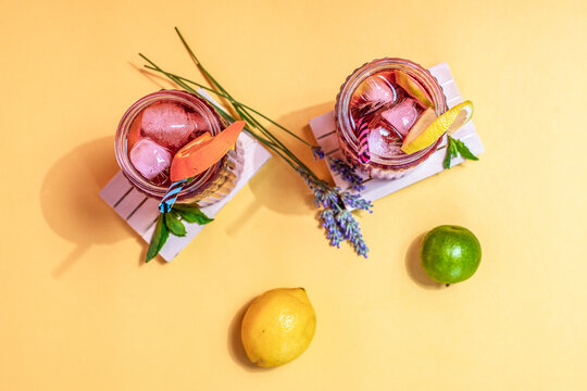 Refreshing summer drinks with citrus and ice cubes
