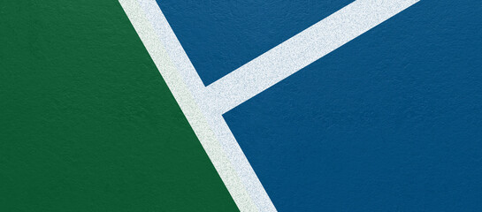 Top view tennis court corner detail with green and blue surface contrast and clean white line intersection