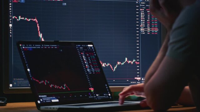 Close up: businessman hands working on laptop or computer keyboard for trading or stock market investing. Male investor sells and buys Bitcoin and crypto coins. Trader chart on terminal monitor.