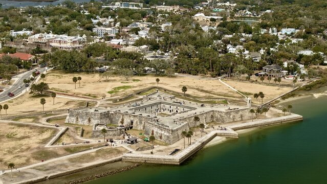 Aerial view of Castillo de San Marcos, a historic fort, stands resolute against the emerald waters, juxtaposed with the city's quaint charm, St. Augustine, Florida, United States.