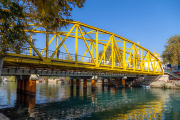 Obraz premium The historic Sari Kopru or Yellow Bridge over the Manavgat River. Iconic metal truss structure from the early Turkish Republic era on a sunny day in Turkey. Heritage architecture.