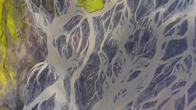 Aerial view of a braided river delta creating a mesmerizing pattern of waterways amidst the landscape, Grindavik, Iceland.