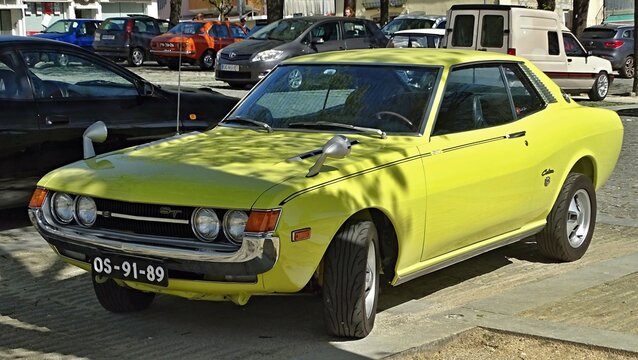 Yellow vintage Toyota Celica GT coupe parked outdoors
