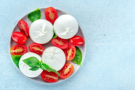 Buffalo Mozzarella, fresh cherry tomatoes, and basil leaves, Caprese salad