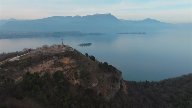 Aerial view of Rocca di Manerba, a promontory with ruins, overlooking the serene waters of Lake Garda, Manerba del Garda, Lombardia, Italy.