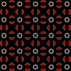 Seamless pattern with repeating coral red and white teardrop shapes arranged in floral motifs on a deep black background, ideal for textile design or digital wallpaper.
