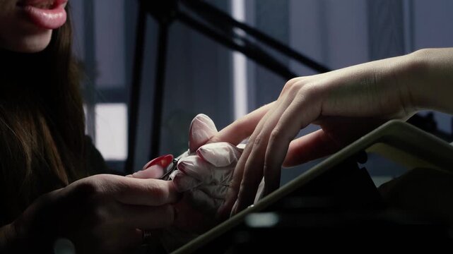beauty master manicurist doing nails to a beautiful young girl in a beauty salon, female beauty and self-care, with her hands and fingers. Close up of handyman tools