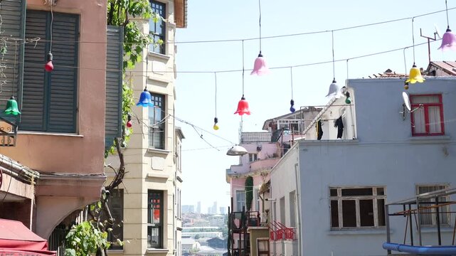 Colorful lanterns hanging over narrow street in historic Balat district of Istanbul Turkey