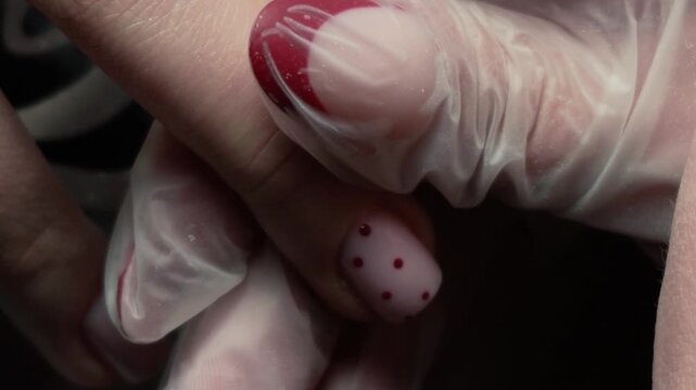 beauty master manicurist doing nails to a beautiful young girl in a beauty salon, female beauty and self-care, with her hands and fingers. Close up of handyman tools