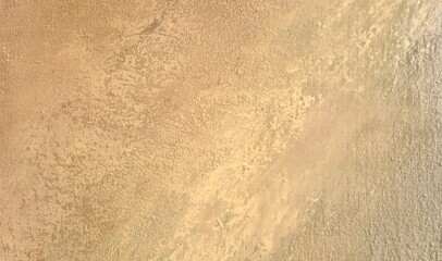 Close-up of abstract oil painting on canvas with warm beige and ochre tones. Visible brush strokes and rich paint texture create a calm, minimal, earthy background ideal for design and art projects