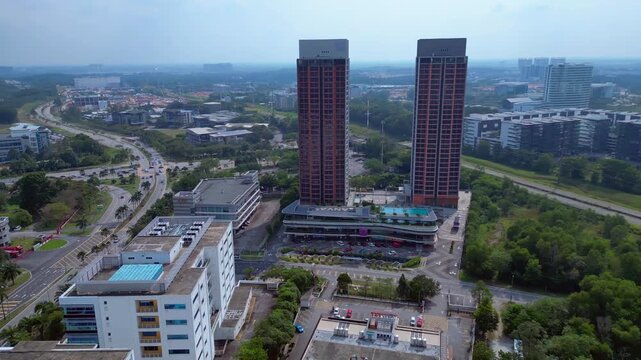 modern buildings at Cyberjaya city , roads and ongoing construction in Malaysia's technology hub, showcasing urban growth. Brilliant aerial view rotation pan to right drone