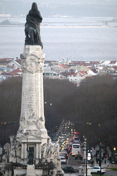 View of Marques de Pombal statue standing tall over bustling city streets and distant shimmering waters, a tranquil yet vibrant scene, Lisboa, Lisboa, Portugal.