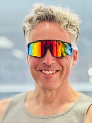 Confident middle aged man wearing reflective sports sunglasses