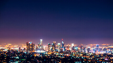 Fototapeta premium A blurred night cityscape with flickering lights and a deep blue sky. Urban, modern atmosphere, the energy of city life. A backdrop for business, technology, marketing, real estate, and presentations
