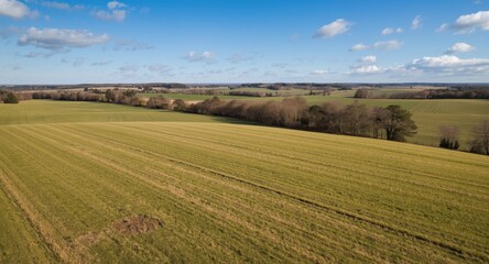 Elevated view of rural farming land featuring broad grassy zones suitable for housing expansion