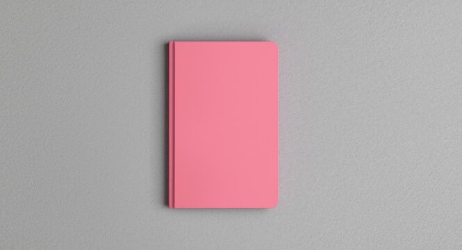 Closed bubblegum pink notebook displayed on a fine grain gray background with copy space