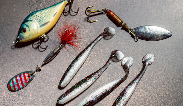 Colorful fishing lures and bobbers arranged on a table ready for successful fishing trip
