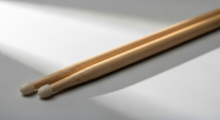 Obraz premium Drumsticks on a light grey background with soft shadows 