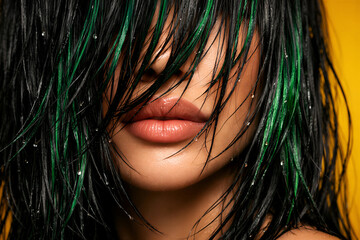 Wet Black Hair with Green Highlights Covering Face on Bold Yellow Background