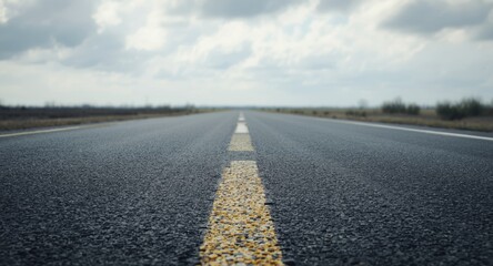 Gray asphalt road surface with minimal markings and clear copy space