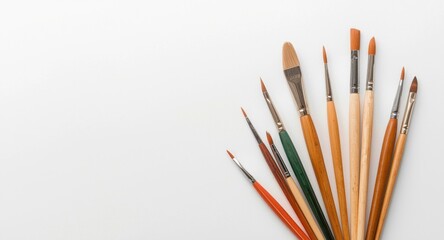 Obraz premium watercolor paint palette and fine brushes positioned on a minimal white background