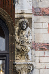 Obraz premium Statue on facade of historic tenement house, located on Saint Bavo Square, Ghent, Belgium