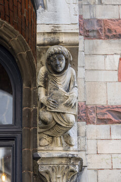 Statue on facade of historic tenement house, located on Saint Bavo Square, Ghent, Belgium