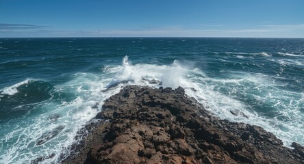 Vigorous ocean waves meeting volcanic landforms in overhead view
