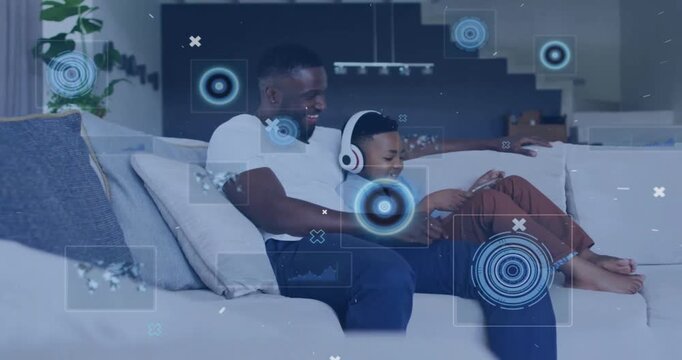 Animation of data processing over african american father and son using tablet