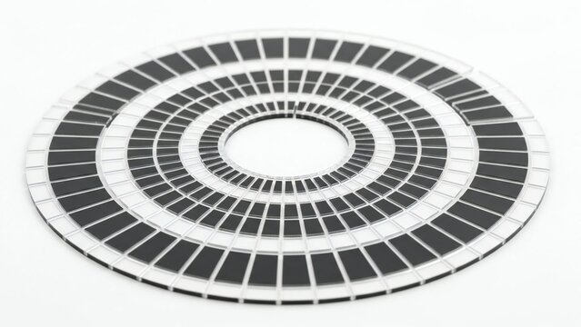 A striking close up of an optical encoder disk featuring concentric rings of black and white squares
