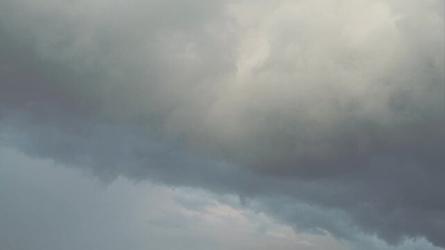 Dark dramatic clouds before a storm. A sky where rain is gradually gathering. The anticipation of a motionless thunderstorm. An abstract background on the theme of bad news.