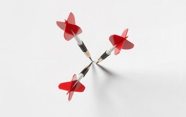 Three red and white darts crossed in the center on a white background, symbolizing accuracy, competition, and hitting the target