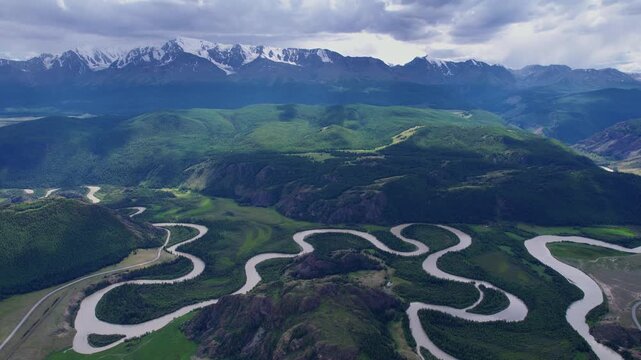 Aerial landscape winding river meander in mountains with forest trees, Altai Russia, top view.