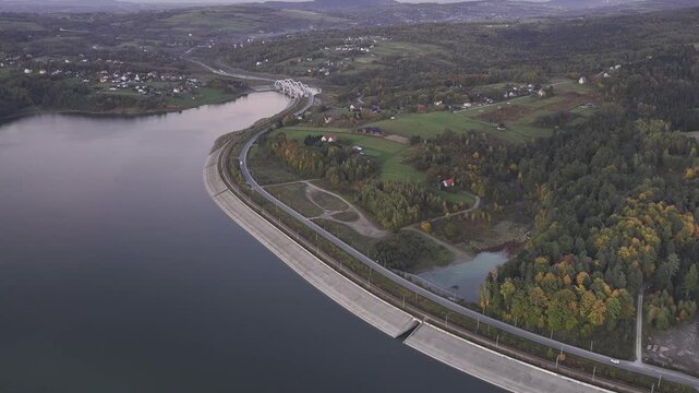 Aerial view of a lake and railway during sunset.
