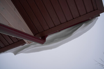 snow drifts on the roof of the house, dangerously overhanging boulders, cyclone