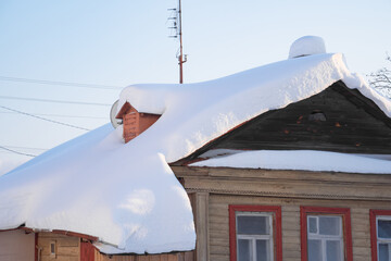 snow drifts on the roof of the house, dangerously overhanging boulders, cyclone