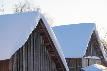 snow drifts on the roof of the house, dangerously overhanging boulders, cyclone
