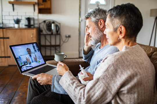 Senior couple video consulting doctor at home