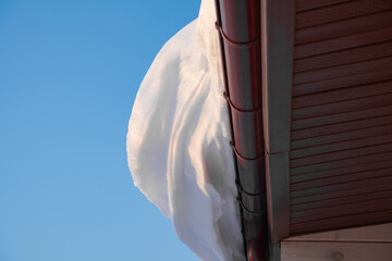 snow drifts on the roof of the house, dangerously overhanging boulders, cyclone