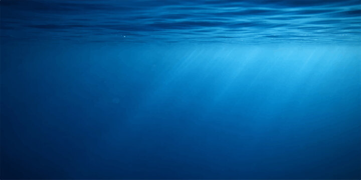 A wide angle underwater view captures sunlight rays piercing through the deep blue ocean surface as scuba diving light reflects across a natural liquid texture