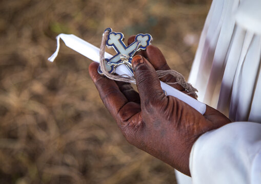 Benin, West Africa, Ganvi&eacute;, celestial church of christ member with a cross and a candle in his hand