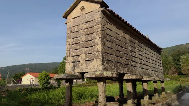 Cinematic camera approach to ancient stone horreo in Galicia