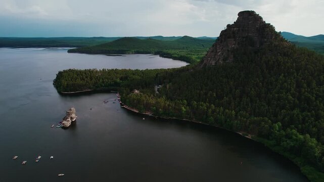 Beautiful landscape of tranquil lake with boat, forests and rocky mountains. Aerial view National nature park Burabay, Kazakhstan.