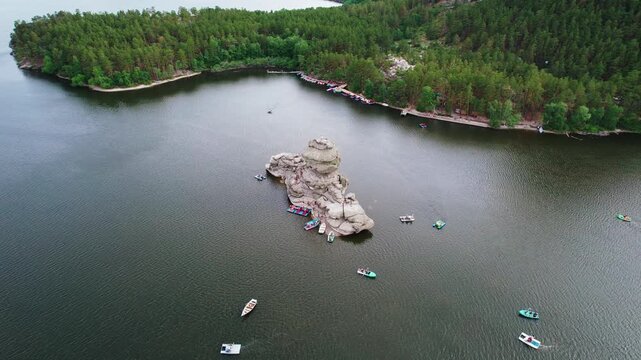 Beautiful landscape of tranquil lake with boat, forests and rocky mountains. Aerial view National nature park Burabay, Kazakhstan.