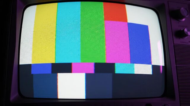 Old television displaying test pattern with distorted colors