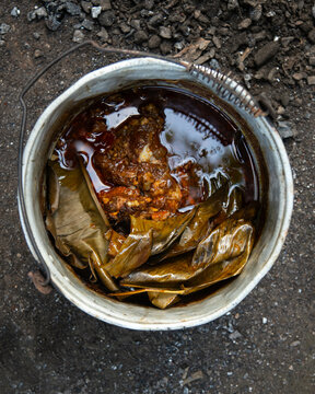 Cooking cochinita pibil. The pib is an earth oven typical of the Yucat&aacute;n Peninsula in Mexico. This pre-Hispanic technique involves digging a pit, lighting a fire with wood and stones, and cooking the 