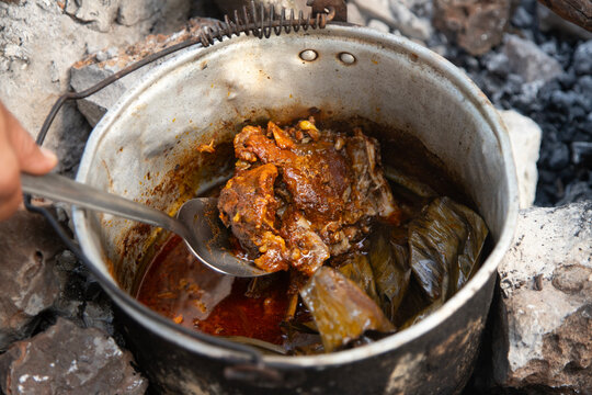 Cooking cochinita pibil. The pib is an earth oven typical of the Yucat&aacute;n Peninsula in Mexico. This pre-Hispanic technique involves digging a pit, lighting a fire with wood and stones, and cooking the 