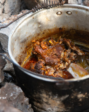 Cooking cochinita pibil. The pib is an earth oven typical of the Yucat&aacute;n Peninsula in Mexico. This pre-Hispanic technique involves digging a pit, lighting a fire with wood and stones, and cooking the 